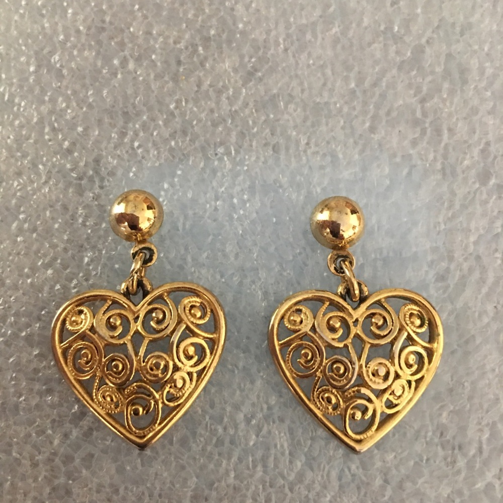 Heart shaped gold tone dangle pierced earrings.